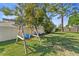 Well-maintained backyard with lush lawn and a wooden swing set for outdoor play and recreation at 3442 Beech Trl, Clearwater, FL 33761