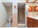 Bathroom features a walk-in shower with glass doors, tile flooring, toilet and vanity at 3442 Beech Trl, Clearwater, FL 33761