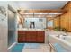 Bathroom with a large mirror, double sinks, glass shower, soaking tub and wood paneled wall at 3442 Beech Trl, Clearwater, FL 33761