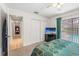 This bedroom features an attached closet, and direct access to a screened-in lanai and pool at 3442 Beech Trl, Clearwater, FL 33761