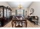 Traditional dining room featuring a wooden table and chairs, complemented by a matching china cabinet at 3442 Beech Trl, Clearwater, FL 33761