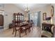Elegant dining room boasting hardwood floors, a large table, and a decorative chandelier, perfect for gatherings at 3442 Beech Trl, Clearwater, FL 33761