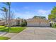 Attractive single-story home boasting a lush green lawn, mature palm trees, and a spacious driveway with a two car garage at 3442 Beech Trl, Clearwater, FL 33761