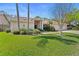 Inviting single-story home with manicured lawn, decorative landscaping, and a two car garage for ample parking at 3442 Beech Trl, Clearwater, FL 33761