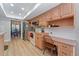 Kitchen with wooden cabinets and stainless steel appliances open to a dining area at 3442 Beech Trl, Clearwater, FL 33761