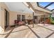 Enjoy outdoor living on this screened-in lanai with ceiling fan, custom bar, and shaded seating area at 3442 Beech Trl, Clearwater, FL 33761