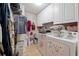 A dedicated laundry room with ample storage cabinets and modern washer and dryer units at 3442 Beech Trl, Clearwater, FL 33761