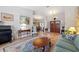 Inviting living room with hardwood floors, a decorative rug, comfortable seating, and open access to other rooms at 3442 Beech Trl, Clearwater, FL 33761