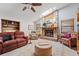 Inviting living room featuring a stone fireplace, skylight, comfortable seating and stylish decor at 3442 Beech Trl, Clearwater, FL 33761