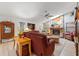 Cozy living room features a stone fireplace, comfortable seating, and natural light from a skylight at 3442 Beech Trl, Clearwater, FL 33761