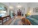 Spacious living room featuring hardwood floors, a large rug, comfortable seating, and access to other rooms at 3442 Beech Trl, Clearwater, FL 33761