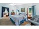 Well-lit main bedroom offers a comfortable bed, neutral tones, and direct access to the main bathroom at 3442 Beech Trl, Clearwater, FL 33761