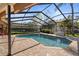 Enjoy this refreshing backyard pool that has brick pavers and a fully screened lanai for outdoor fun at 3442 Beech Trl, Clearwater, FL 33761