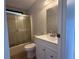 This bathroom features a shower with glass doors, a toilet, a vanity, and a sink at 37542 Pinata Ave, Zephyrhills, FL 33541