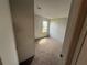 This bedroom features neutral walls, carpet flooring and a window letting in natural light at 37542 Pinata Ave, Zephyrhills, FL 33541