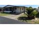 Charming single-story home featuring a carport, screened porch, and well-maintained landscaping at 37542 Pinata Ave, Zephyrhills, FL 33541