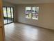 Bright living room featuring neutral flooring and natural light from large windows at 37542 Pinata Ave, Zephyrhills, FL 33541