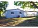 Rear view of the house featuring a well maintained lawn and ample yard space at 3905 W Carmen St, Tampa, FL 33609