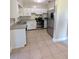 Bright kitchen featuring stainless steel appliances and white cabinetry at 3905 W Carmen St, Tampa, FL 33609