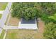 An overhead capture showing roof shape and surrounding landscape elements including walkway, trees and well maintained grass at 4005 W Nassau St, Tampa, FL 33607