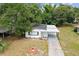 An aerial view of the home showcasing its updated roof and landscaping at 4005 W Nassau St, Tampa, FL 33607