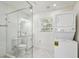 Bathroom featuring a glass-enclosed shower, vanity, and stacked washer and dryer at 4005 W Nassau St, Tampa, FL 33607