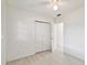 Bright bedroom features a ceiling fan, closet, and light laminate flooring at 4005 W Nassau St, Tampa, FL 33607