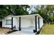 Angle view of a single-story home's inviting front with a covered porch and black support beams at 4005 W Nassau St, Tampa, FL 33607