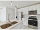 Bright kitchen with stainless steel appliances, quartz countertops and white cabinetry at 4005 W Nassau St, Tampa, FL 33607