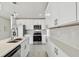 Modern kitchen boasts white cabinets, stainless steel appliances, and stylish countertops at 4005 W Nassau St, Tampa, FL 33607