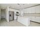 Modern kitchen featuring stainless steel appliances, white cabinetry, and a quartz-topped island at 4005 W Nassau St, Tampa, FL 33607