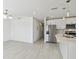 Open-concept kitchen with stainless steel appliances, white cabinets, and modern lighting at 4005 W Nassau St, Tampa, FL 33607