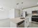 Open kitchen featuring a large island with a sink and modern stainless steel appliances at 4005 W Nassau St, Tampa, FL 33607