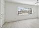 Bright living room featuring light-colored wood flooring and a large window for natural light at 4005 W Nassau St, Tampa, FL 33607