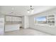 Open-concept living area with a modern kitchen, natural light, and sleek flooring at 4005 W Nassau St, Tampa, FL 33607
