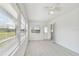 Sunroom bathed in light with many windows, leading to a door and offering serene views at 4005 W Nassau St, Tampa, FL 33607