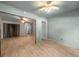 Open bedroom featuring light green color scheme, wood-look flooring, and ceiling fan at 426 32Nd N Ave # 102E, St Petersburg, FL 33704