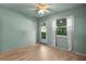 Bedroom featuring light green walls, wood-look floors, and a glass paneled door at 426 32Nd N Ave # 102E, St Petersburg, FL 33704