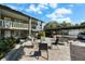 Relaxing common area offers an inviting outdoor space with multiple chairs and green landscaping at 426 32Nd N Ave # 102E, St Petersburg, FL 33704