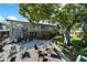 Outdoor patio with multiple seating areas, perfect for entertaining or relaxing in a lush landscaped setting at 426 32Nd N Ave # 102E, St Petersburg, FL 33704