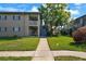 Inviting two-story condo building with well-maintained lawn and mature trees, creating a serene outdoor environment at 426 32Nd N Ave # 102E, St Petersburg, FL 33704