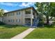 A charming two-story apartment building showcases a manicured lawn and inviting walkway at 426 32Nd N Ave # 102E, St Petersburg, FL 33704