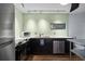 Modern kitchen with stainless steel appliances, quartz countertops, and wood-style flooring at 426 32Nd N Ave # 102E, St Petersburg, FL 33704