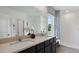 Modern bathroom featuring dual sinks, granite countertops, dark cabinets and a glass shower enclosure at 4427 Sand Dollar Way, Zephyrhills, FL 33541