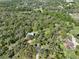 Aerial shot showcasing the home in the midst of a wooded environment at 4532 Spring Rd, Valrico, FL 33596