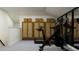 Well-equipped exercise room with a stationary bike, treadmill, and storage units at 4897 Southern Valley Loop, Brooksville, FL 34601