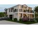Modern home with a two-car garage, balcony, and lush landscaping at 5000 Chancellor Ne St, St Petersburg, FL 33703