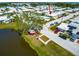 Aerial view shows home's proximity to the pond and gazebo with lush trees and the neighborhood beyond at 5427 Springwood Blvd # 5427, Pinellas Park, FL 33782