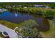Scenic aerial view of community lake with lush surroundings, a fountain, and adjacent recreational areas at 5427 Springwood Blvd # 5427, Pinellas Park, FL 33782