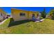 Backyard features a patio set on a stone patio and well-maintained grassy area at 5427 Springwood Blvd # 5427, Pinellas Park, FL 33782